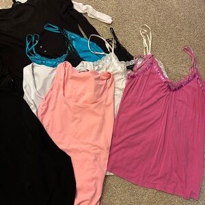 An entire bundle of gently used tank tops, shirts, and a simple black dress.